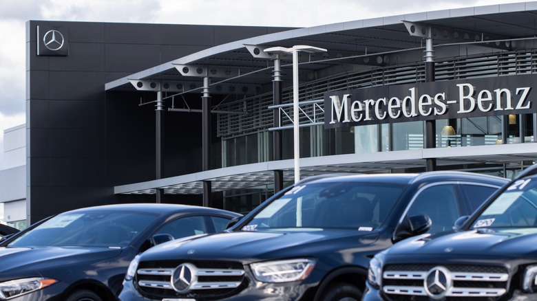 Cars parked in front of a Mercedes-Benz dealership