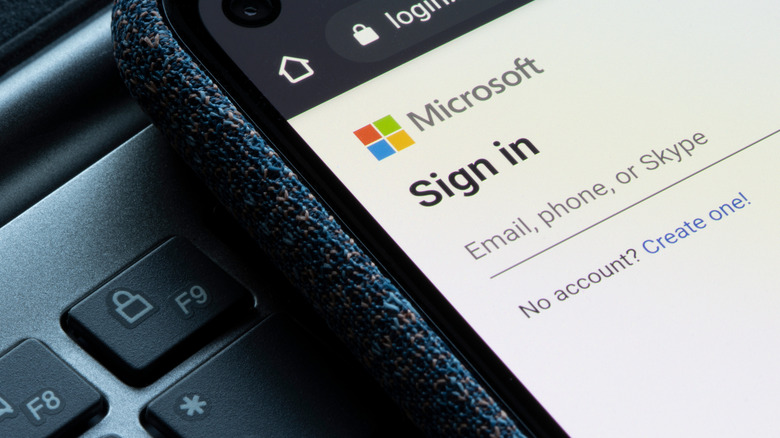 The login page of Outlook, Microsoft's web-based email service, is seen on a smartphone