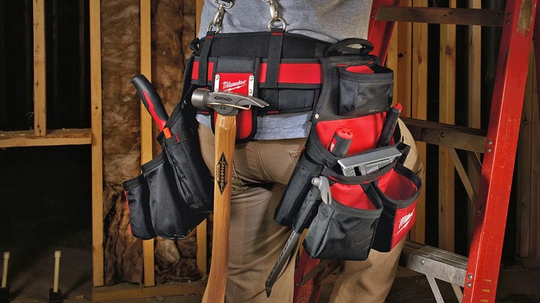 A person wearing a Milwaukee tool belt.