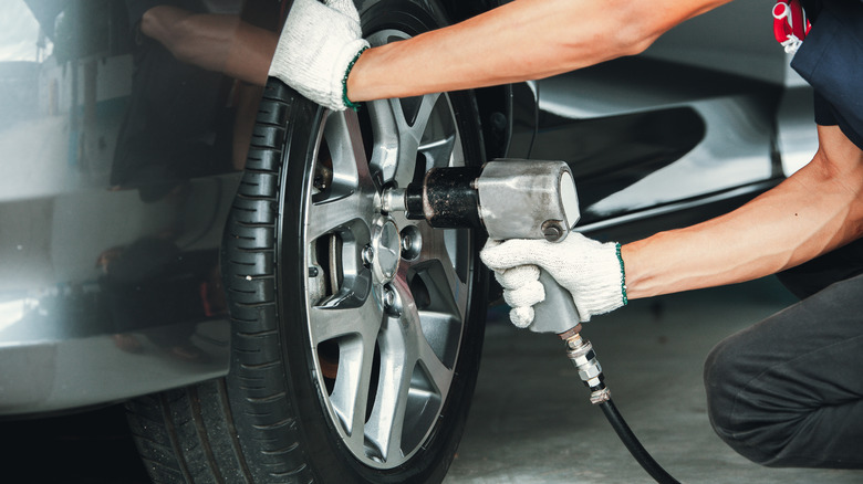 man using impact wrench