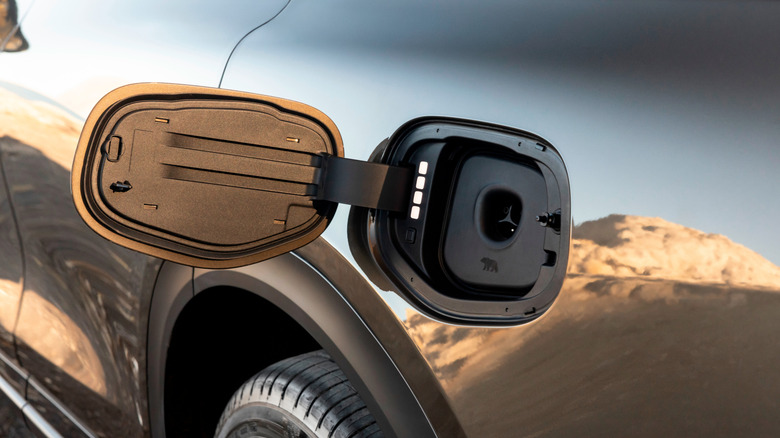 Close up of the fuel cap of Grey Lucid Air Pure parked under a tree at a house