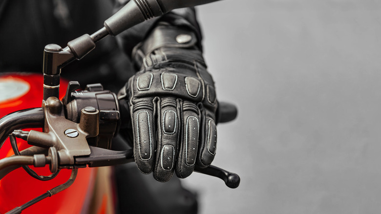 Motorcycle rider's hand in a full gauntlet glove