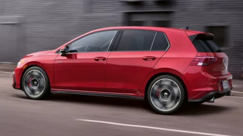 The Volkswagen Golf GTI zipping down a city street.