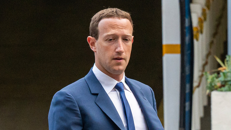 Zuckerberg wearing suit walking