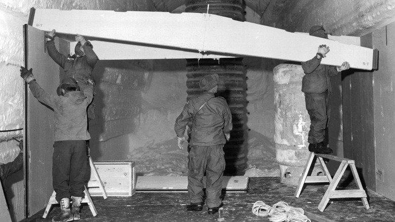 People constructing a truss at Camp Century.