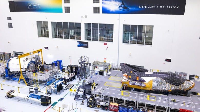 Sierra Space Dream Chaser spaceplane and cargo module on platforms for construction