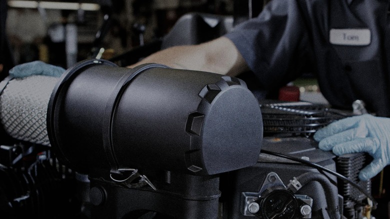 A technician working on a Kohler, Rehlko, engine