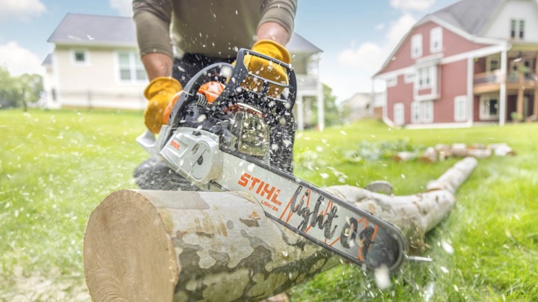 Person cutting wood with a Stihl chainsaw