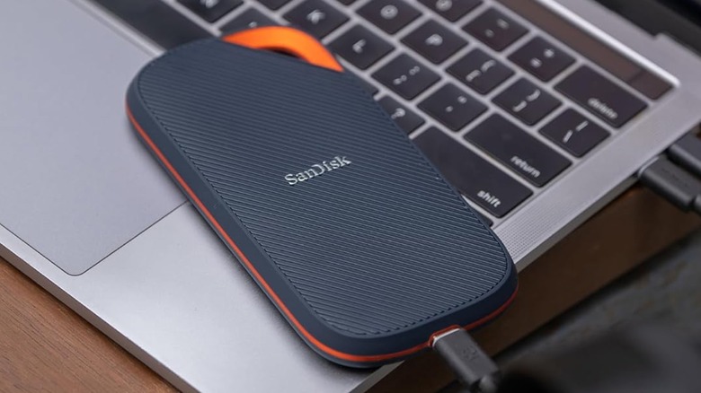 A SanDisk Extreme PRO external SSD plugged into a laptop with a USB cable