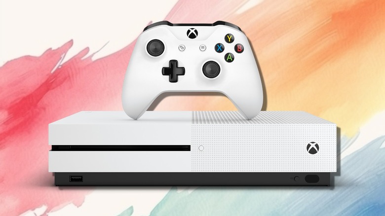 An Xbox controller on top of an Xbox Series S.