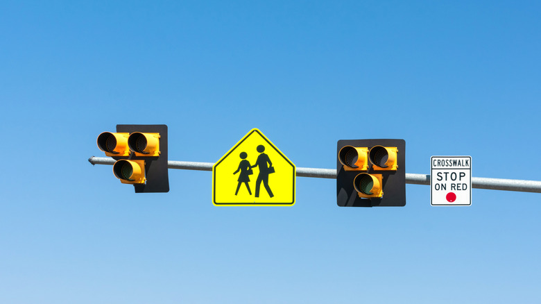 Pedestrian hybrid beacon traffic lights against blue sky