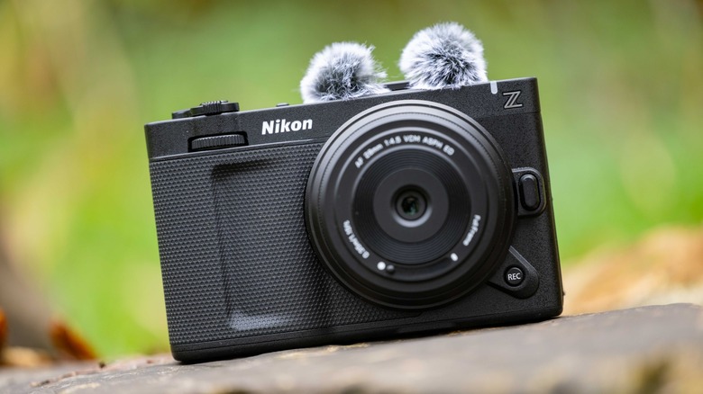 The Nikon Zr with Viltrox 28mm AF f4.5 lens and SmallRig windshield on a rock.