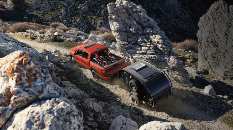 2025 Nissan Frontier PRO-4X towing a trailer on a rocky terrain