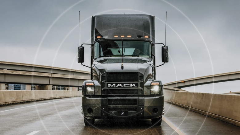 a Mack Truck driving down the road