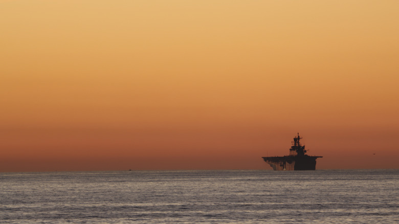 Aircraft carrier at sunset