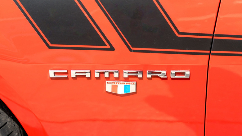 camaro with red white and blue emblem