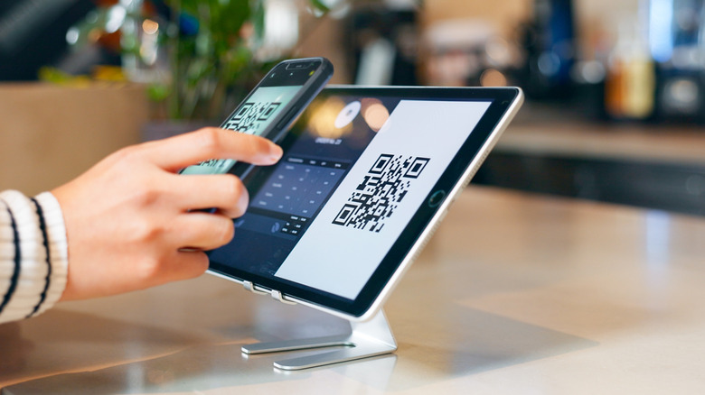 Person scanning a QR code