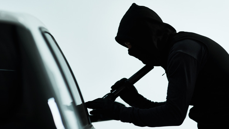 Man talking on phone outside of car
