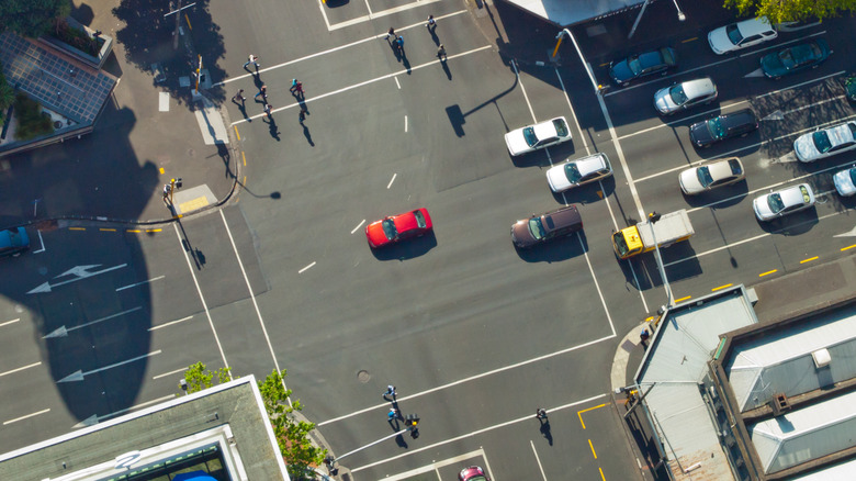 An overhead view of a busy four-way intersection with multiple lanes