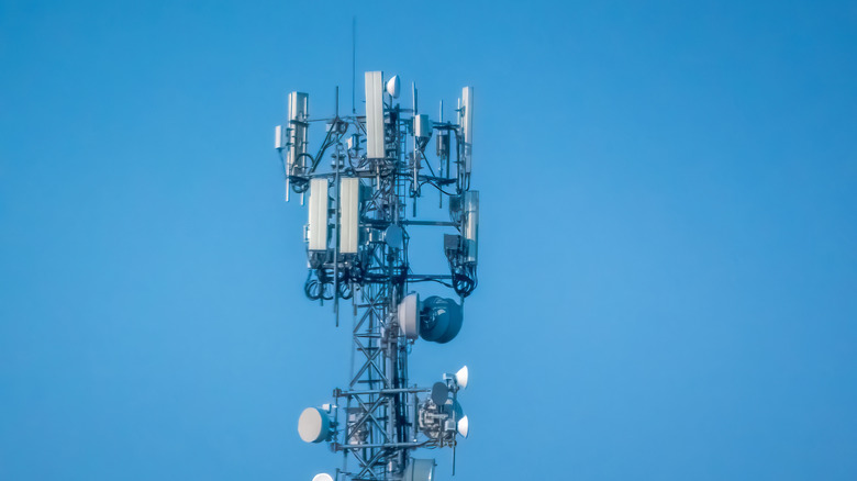 The top of a cell tower against a blue sky