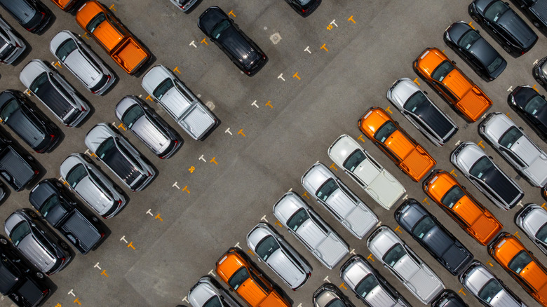 Top-down view of a dealership lot with SUVs and pickup trucks