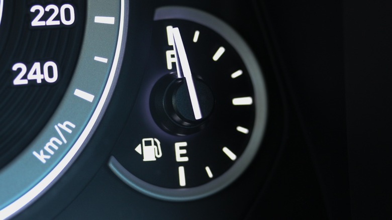 Close-up photo of a black dashboard with a full fuel guage