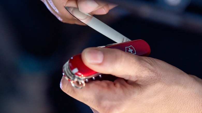 Person unfolding a Swiss Army Knife blade