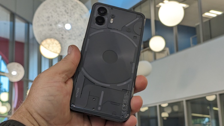 Man holding Nothing Phone (2)