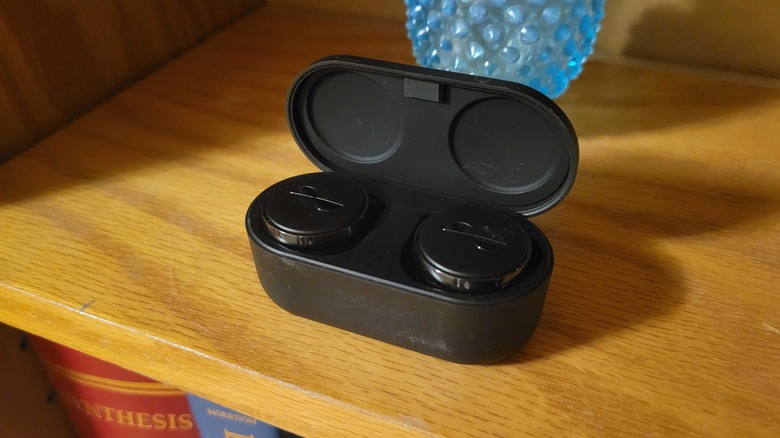 NuraTru Pro buds in the case on a shelf