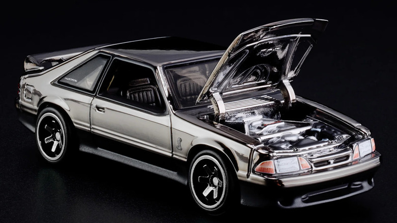 Hot Wheels RLC 1993 Ford Mustang Cobra R with hood up on black background