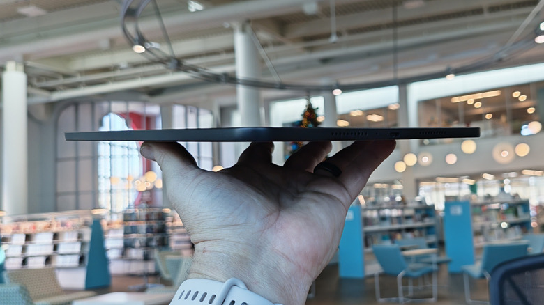 Man holding the OnePlus Pad 2 Go