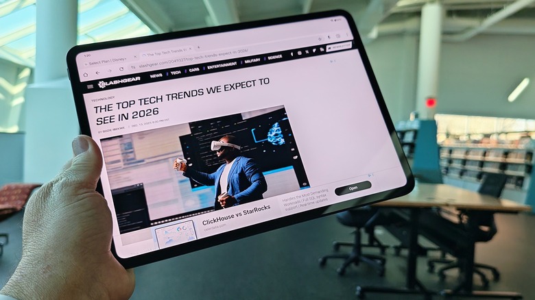Man holding the OnePlus Pad 2 Go