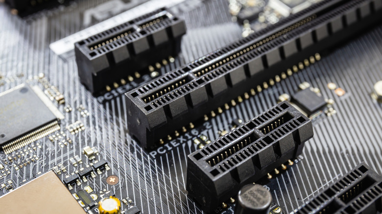 A close up of four rows of PCIe slots or lanes on a motherboard.