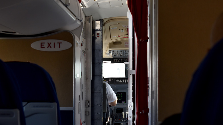 Looking into the cockpit of an airliner through an open cockpit door