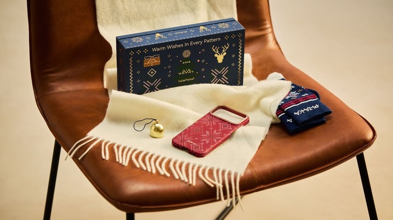 Contens of the PITAKA Christmas Box displayed on a brown chair with an ivory scarf