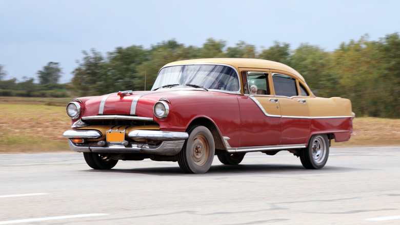 A red Pontiac with a brown hard top