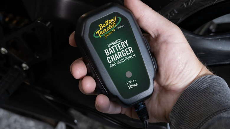 The Battery Tender Junior controller being held in a hand