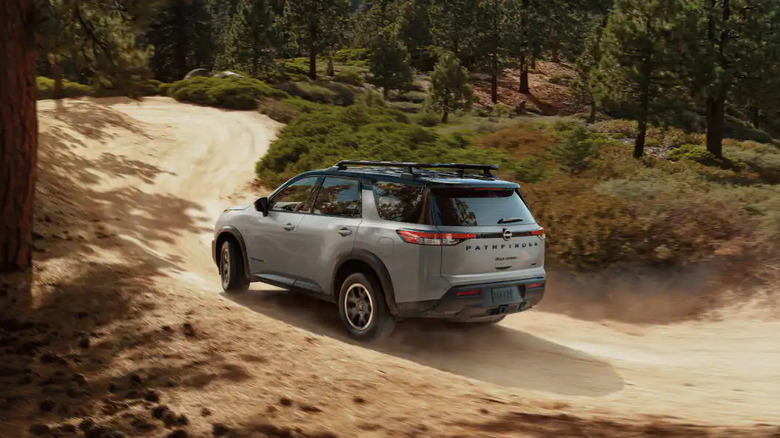 2025 Nissan Pathfinder on dirt road in the woods
