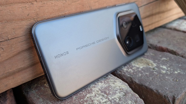 Porsche Design Honor phone on brick and wood.