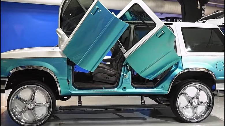 Customized 1992 Ford Explorer with scissor doors open, left-side view