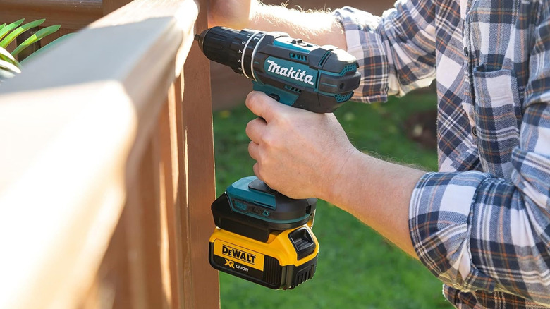 Makita drill using DeWalt battery with power tool battery adapter