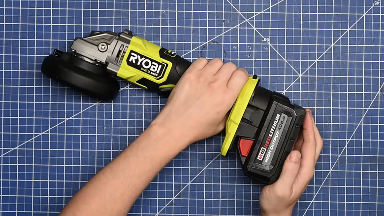 Ryobi tool connected to Milwaukee battery using power tool battery adapter