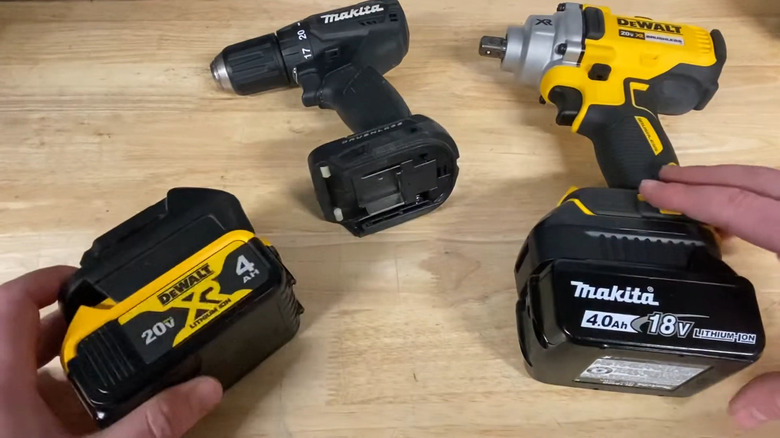 DeWalt and Makita tools exchanging batteries using power tool battery adapters