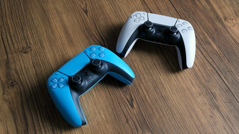 Blue and White Dualsense controllers