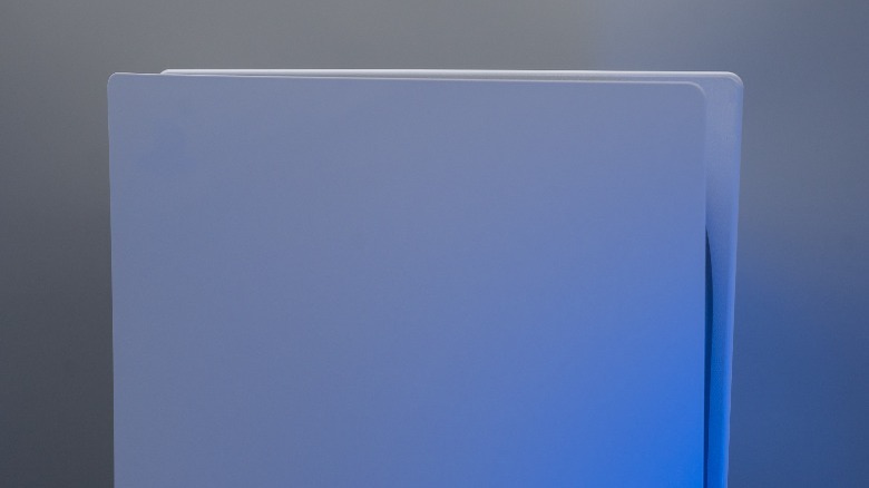 A PlayStation 5 against a grey background