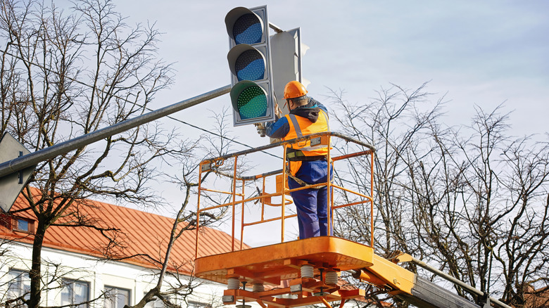 Man working on a traffic light