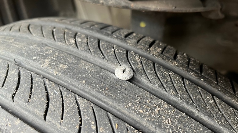 Close-up of a nail embedded in a tire