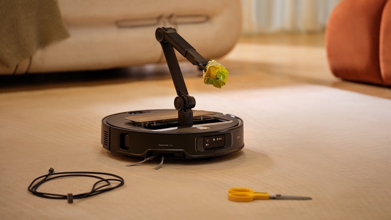 Roborock Saros Z70 picking up an object with its OmniGrip robotic arm