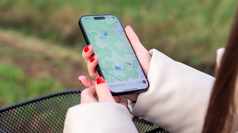 Zoomed in image of iPhone in hand with Maps open