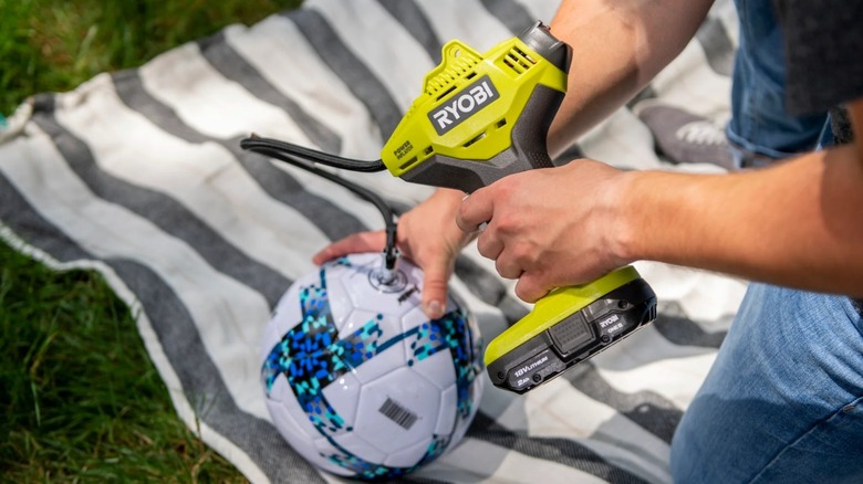Using a Ryobi inflator equipped with the standard One+ battery to air up a ball.